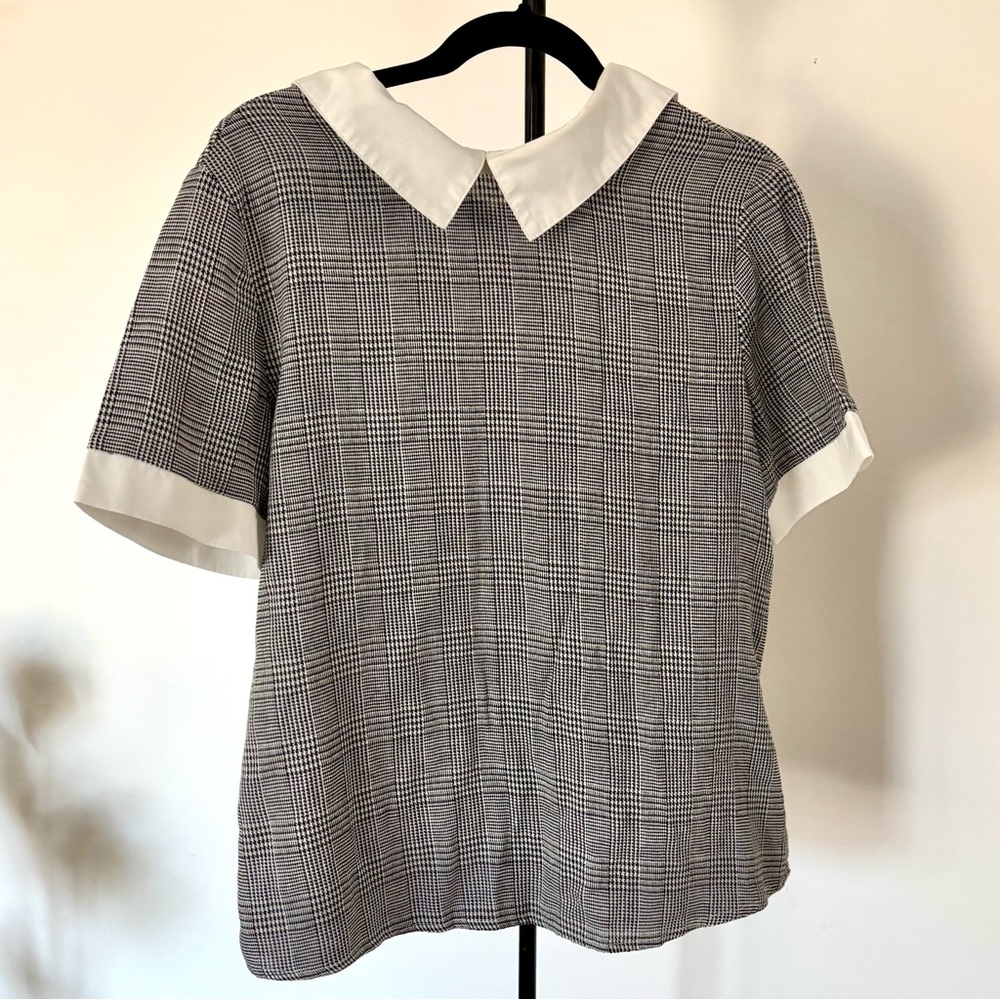 black/dark grey plaid shirt with white collar accents